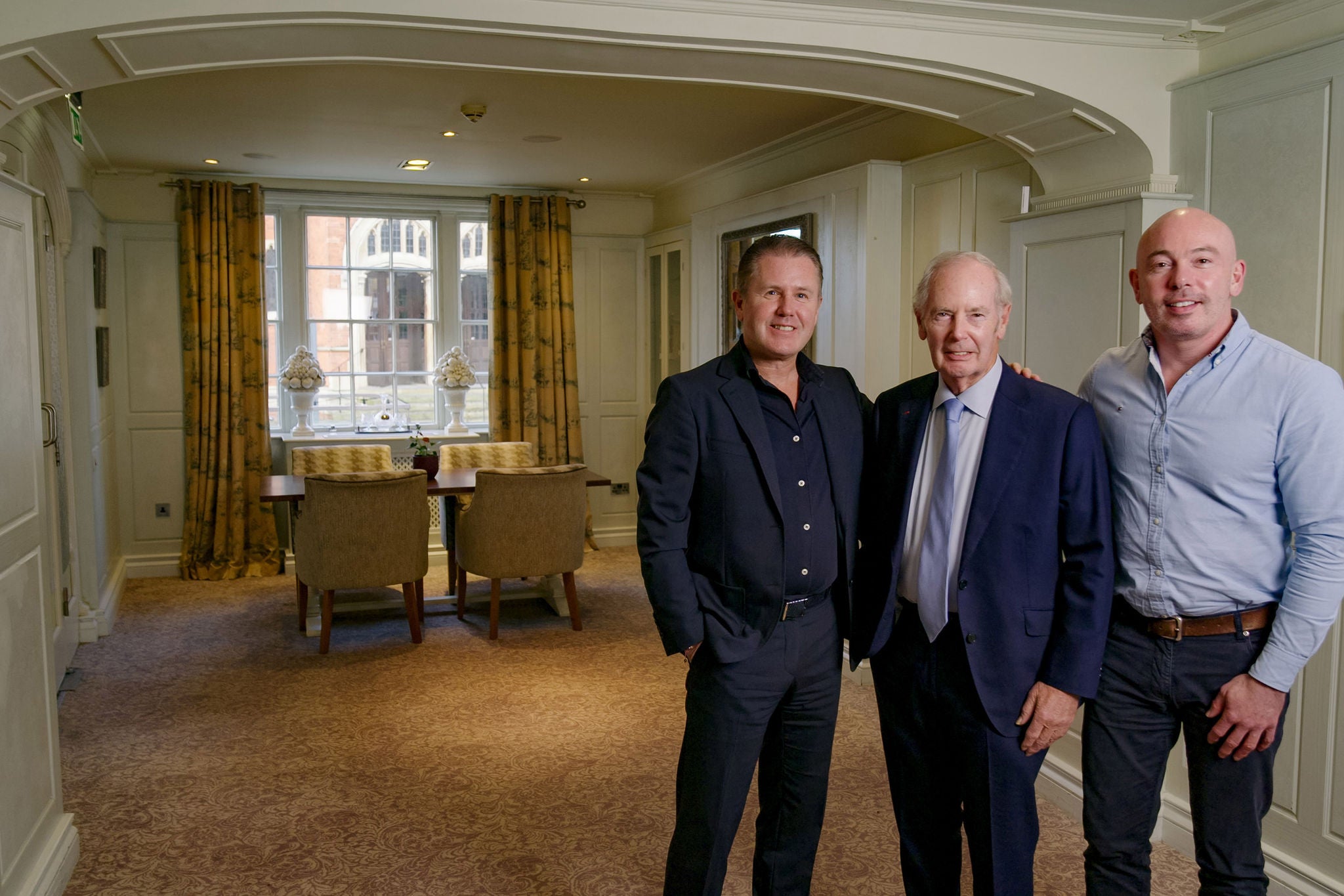 A portrait of James Rigby, Sir Peter Rigby and Steve Rigby in a hotel